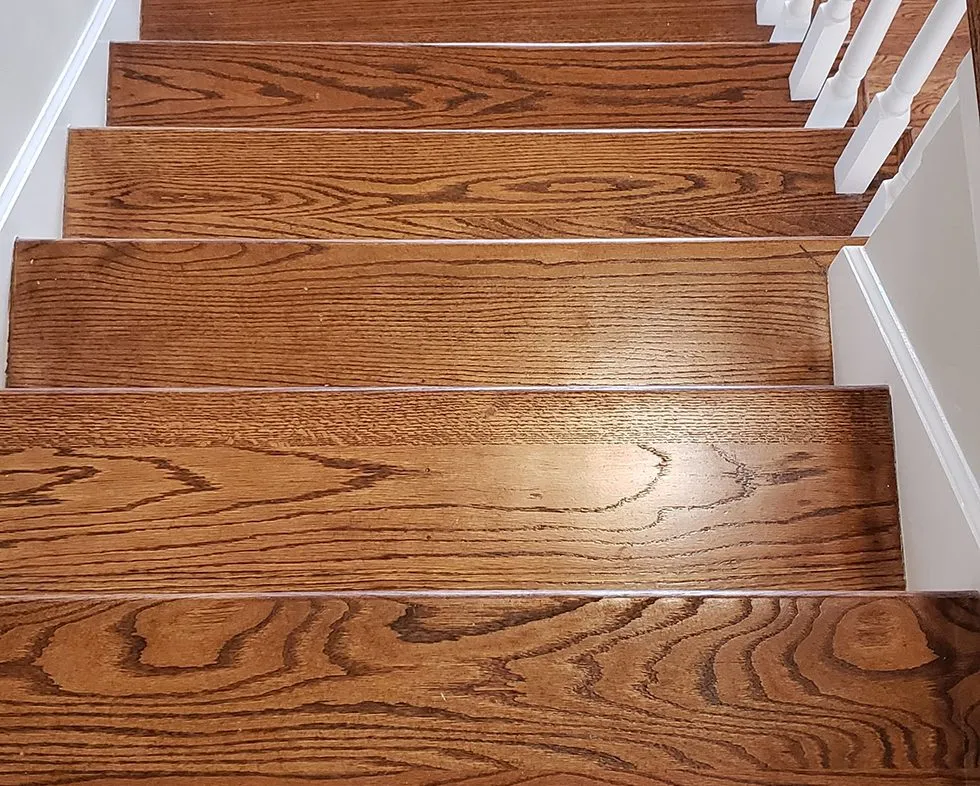 Refinished hardwood stair treads matched to the surrounding floor